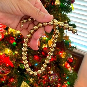 Gold necklace. The beads are substantially good quality. Not cheap feeling on.